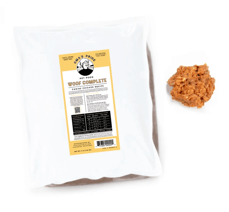 Rear label of the white 6-pound Oma’s Pride Woof Complete Canine Chicken Recipe package beside a serving of the frozen raw food.